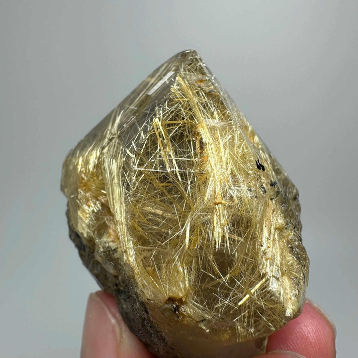 Gold rutilated quartz and specular hematite specimen with golden needles, perfect for solar plexus and root chakra healing.