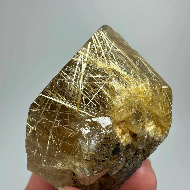 Gold rutilated quartz and specular hematite specimen with golden needles and metallic sheen for solar plexus healing.