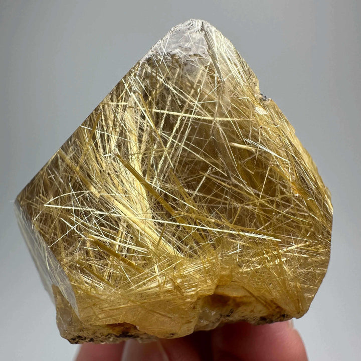 Gold rutilated quartz specimen with metallic specular hematite, featuring golden needles for solar plexus chakra healing.