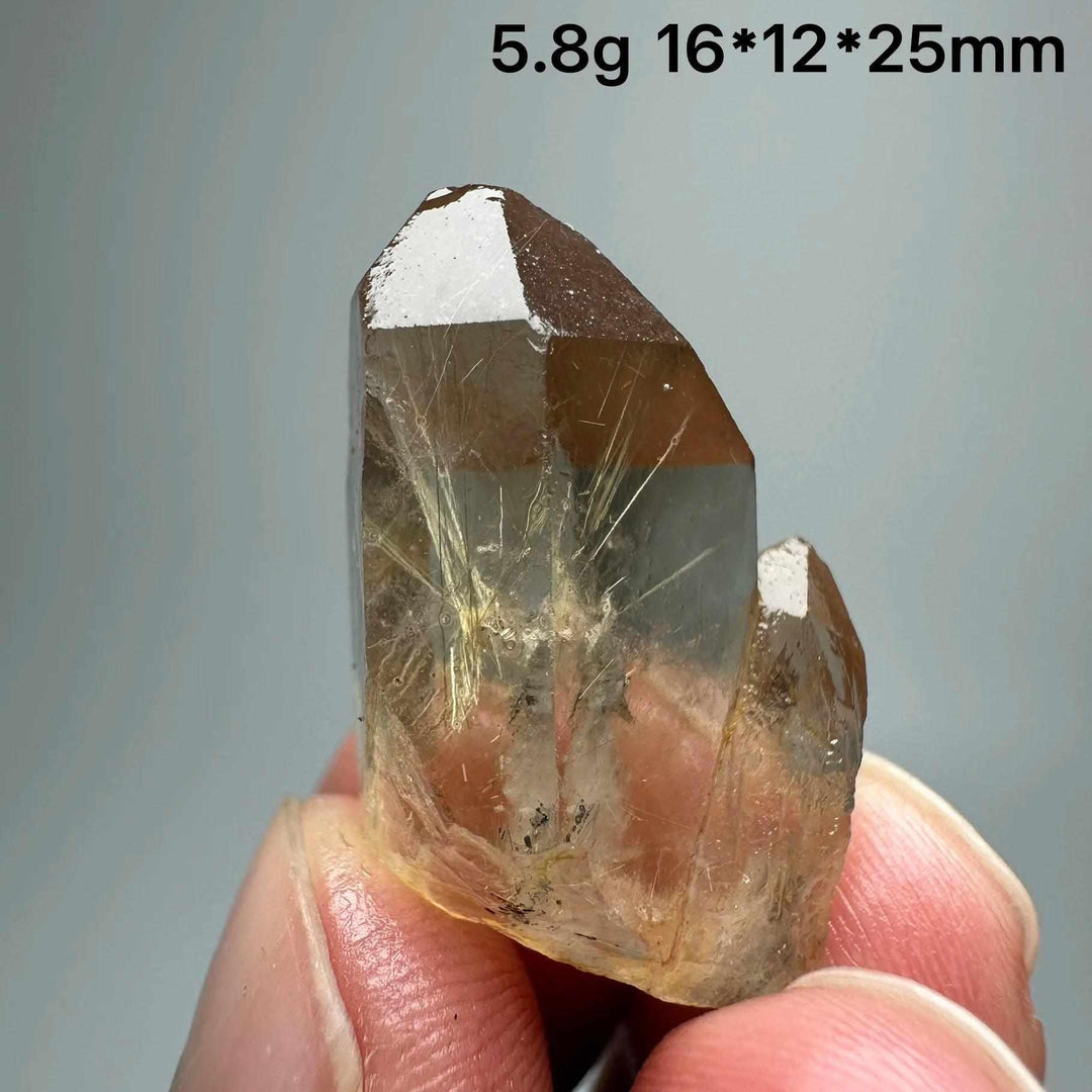 Gold rutilated quartz and specular hematite crystal specimen with golden needles, perfect for solar plexus chakra healing.