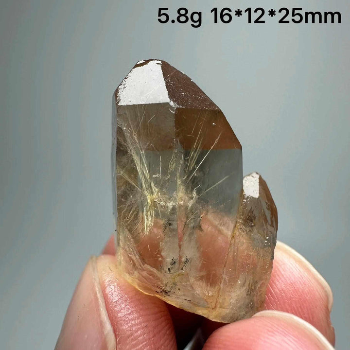 Gold rutilated quartz and specular hematite crystal specimen with golden needles, perfect for solar plexus chakra healing.