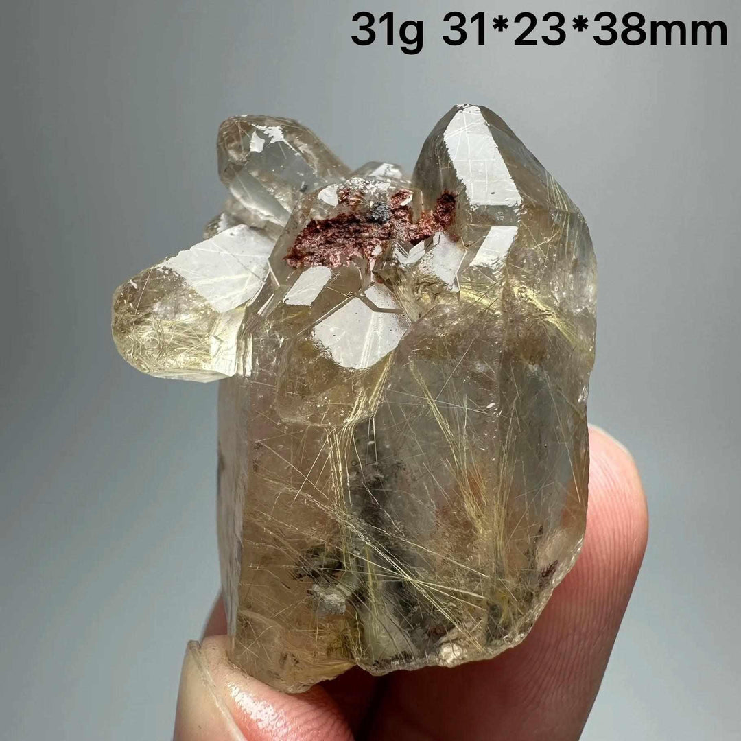 Gold rutilated quartz and specular hematite specimen with golden needles and metallic sheen for solar plexus healing.