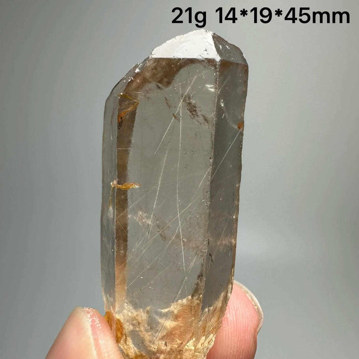 Gold rutilated quartz and specular hematite crystal specimen with golden needles and mirror-like sheen for chakra healing.