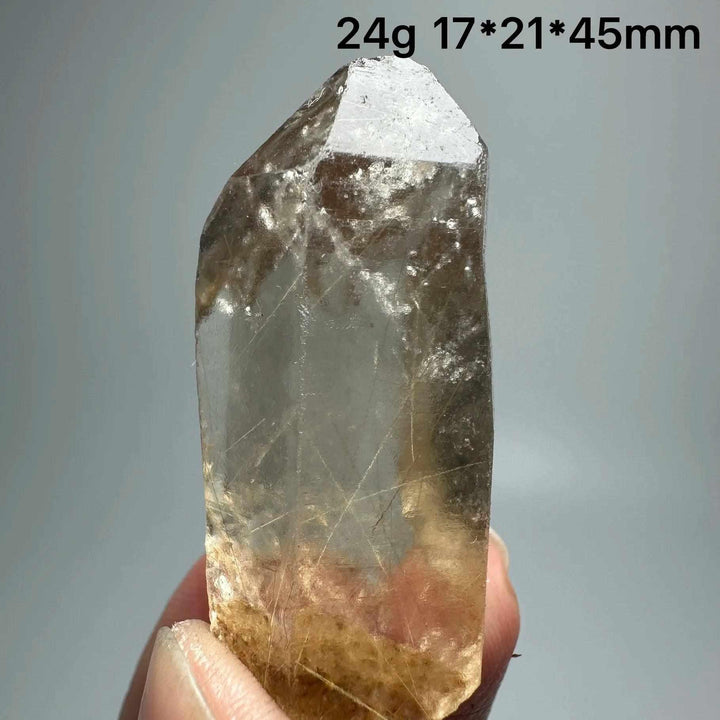 Gold Rutilated Quartz and Specular Hematite crystal point with golden needles and metallic sheen for chakra healing.