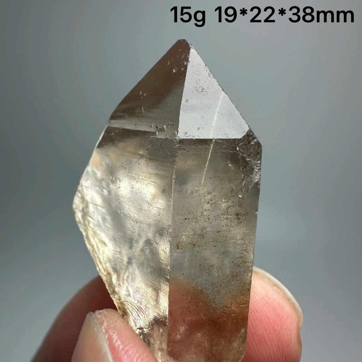 Gold rutilated quartz and specular hematite crystal point with metallic inclusions, perfect for grounding and energy.