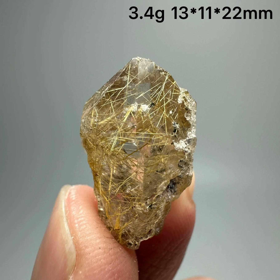 Gold rutilated quartz and specular hematite specimen with golden needles, perfect for solar plexus and root chakra healing.
