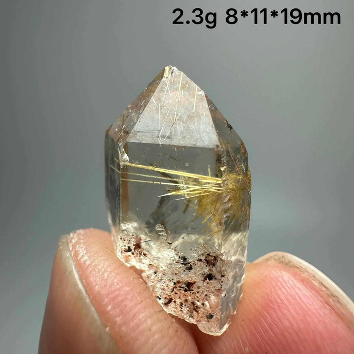 Gold rutilated quartz and specular hematite crystal point with golden needles, perfect for solar plexus and root chakras.