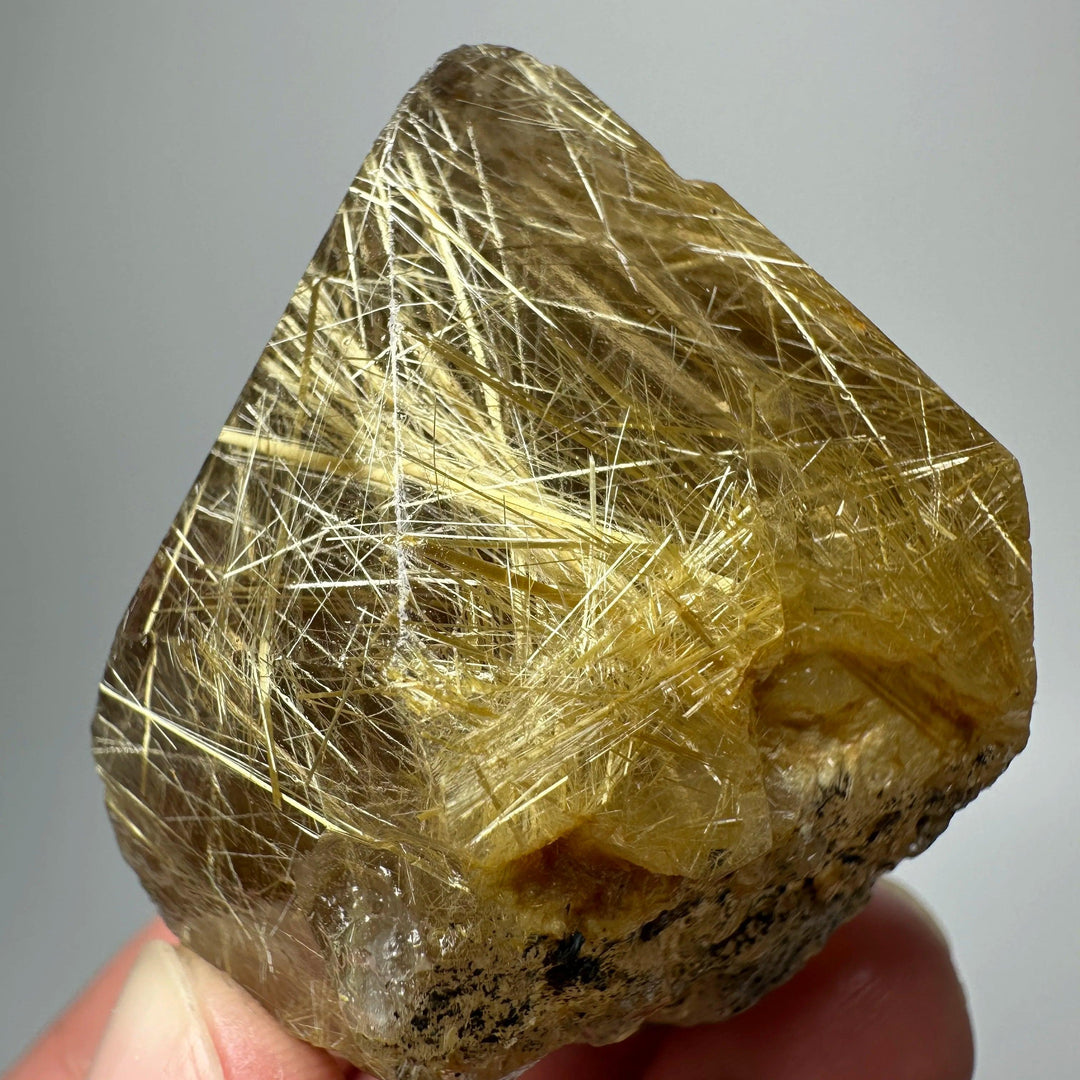 Gold rutilated quartz and specular hematite specimen with golden needles and metallic sheen for solar plexus healing.