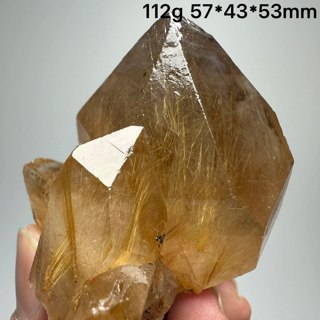 Golden Rutilated Quartz crystal with specular hematite, 112g, 57x43x53mm, promoting healing and energy.