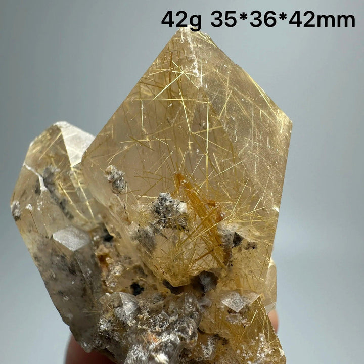 Natural Brazil Gold Rutilated Quartz crystal with golden hair-like inclusions and specular hematite symbiosis.