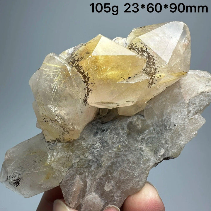 Natural Brazil Gold Rutilated Quartz crystal specimen with specular hematite, showing golden needles and clear quartz.