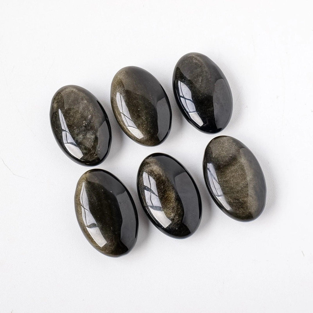Six polished Gold Sheen Obsidian palm stones with a deep black volcanic base and shimmering golden glow for grounding.