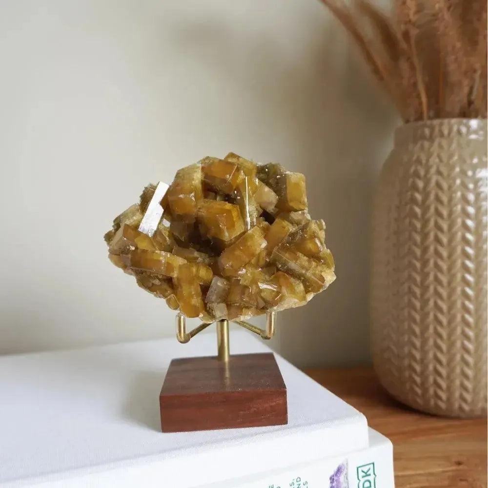 Radiant Golden Barite Crystal Cluster on a stand, showcasing warm honey-gold blades for abundance and spiritual insight.