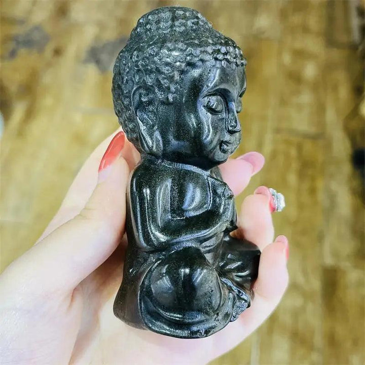 Golden Obsidian Crystal Carved Seated Buddha Statue, deep glassy black with warm golden shimmer, grounding and serene.