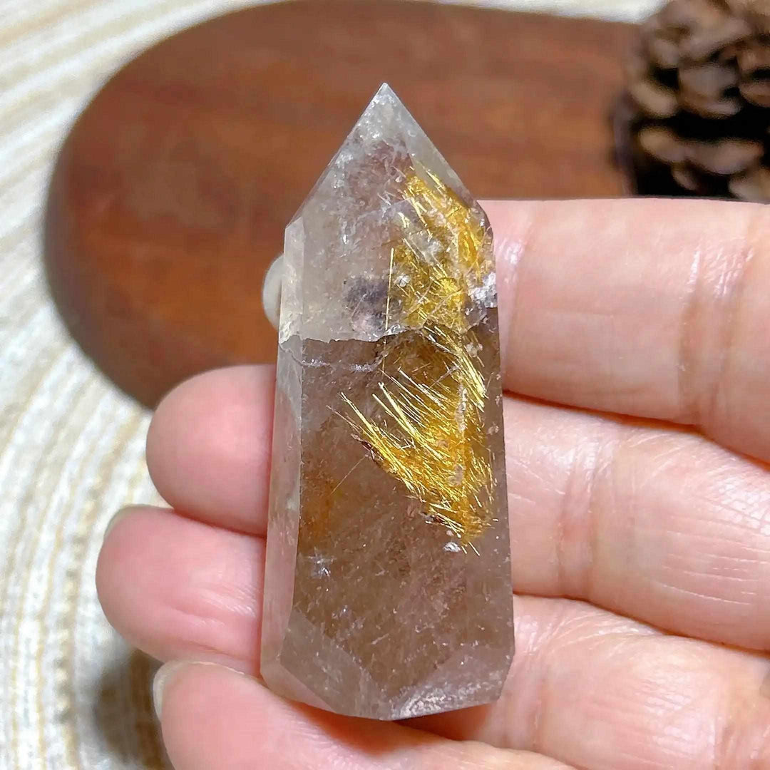 Hand-polished Golden Rutilated Quartz tower featuring clear crystal with vibrant golden rutile needles for energy focus.