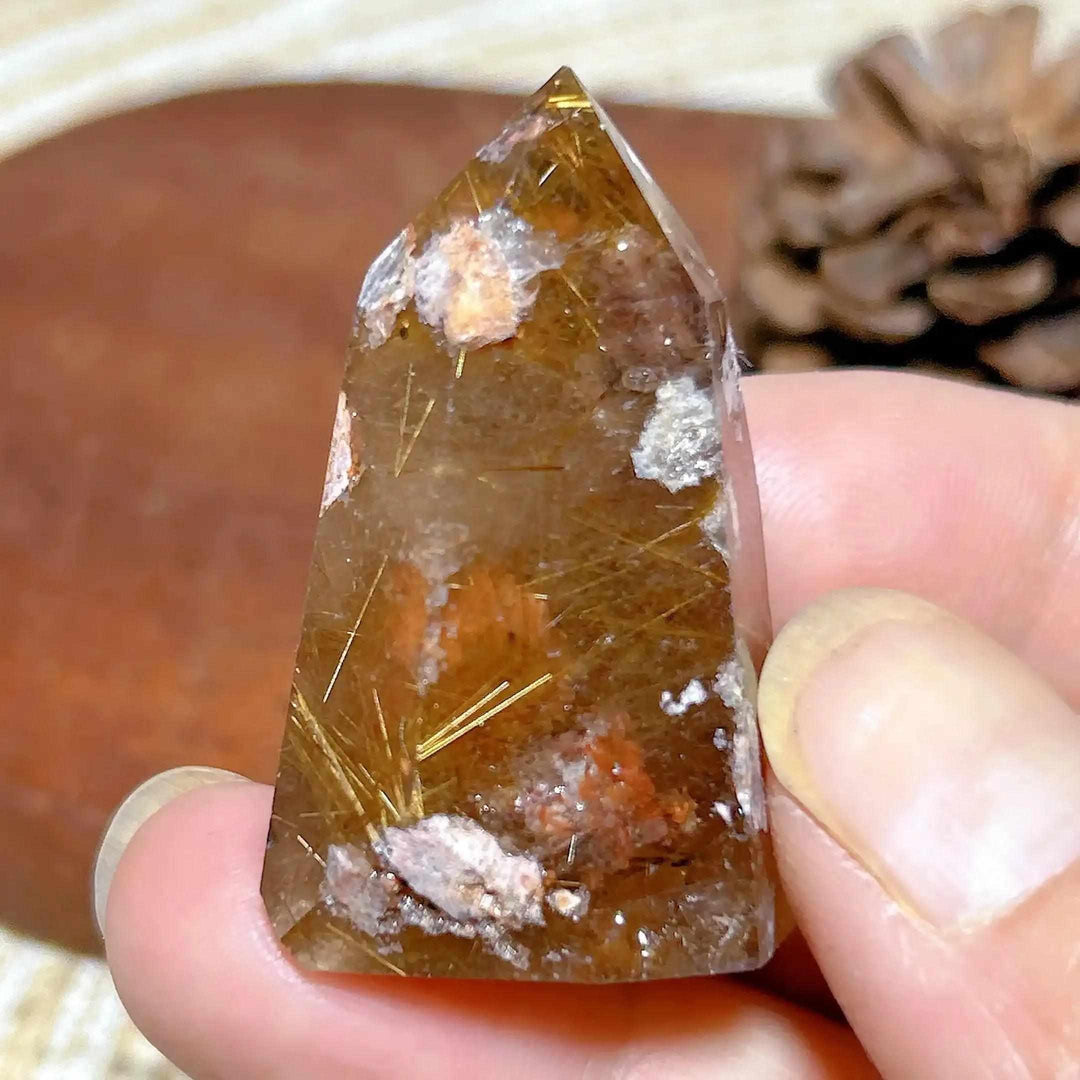 Hand-polished Golden Rutilated Quartz tower featuring clear crystal with fine golden rutile needles for energy focus.