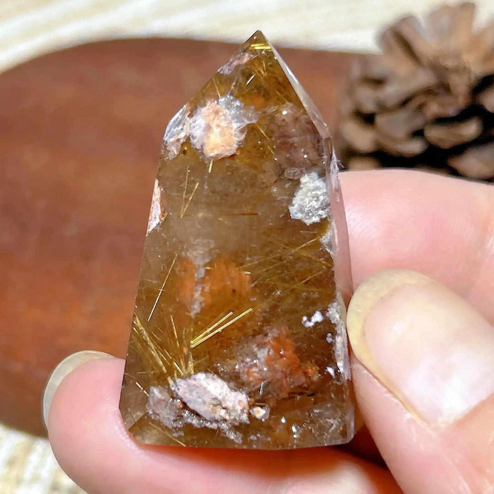 Hand-polished Golden Rutilated Quartz tower featuring clear crystal with fine golden rutile needles for energy focus.