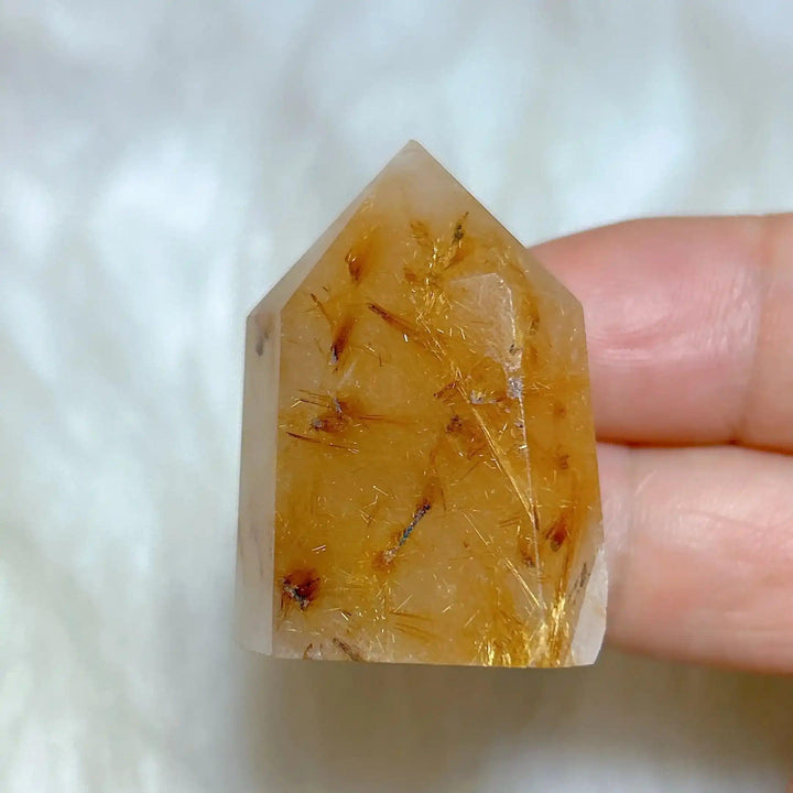 Hand-polished Golden Rutilated Quartz tower featuring clear crystal with fine golden rutile needles for amplified energy.