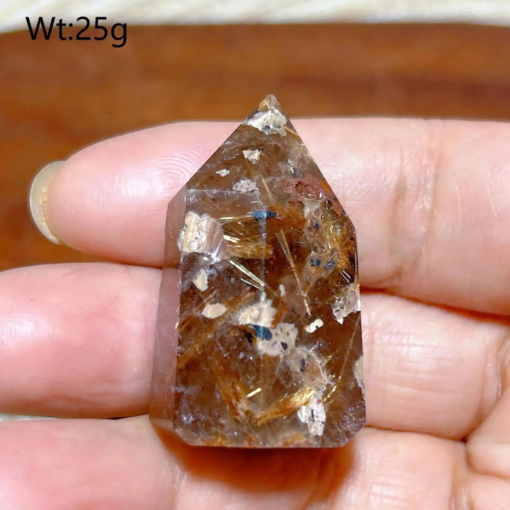 Hand-polished Golden Rutilated Quartz tower with golden needles, perfect for amplifying energy and focus.