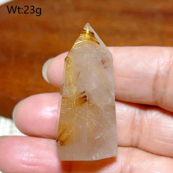 Hand-held Golden Rutilated Quartz tower featuring clear crystal with fine golden rutile needles for amplified energy.