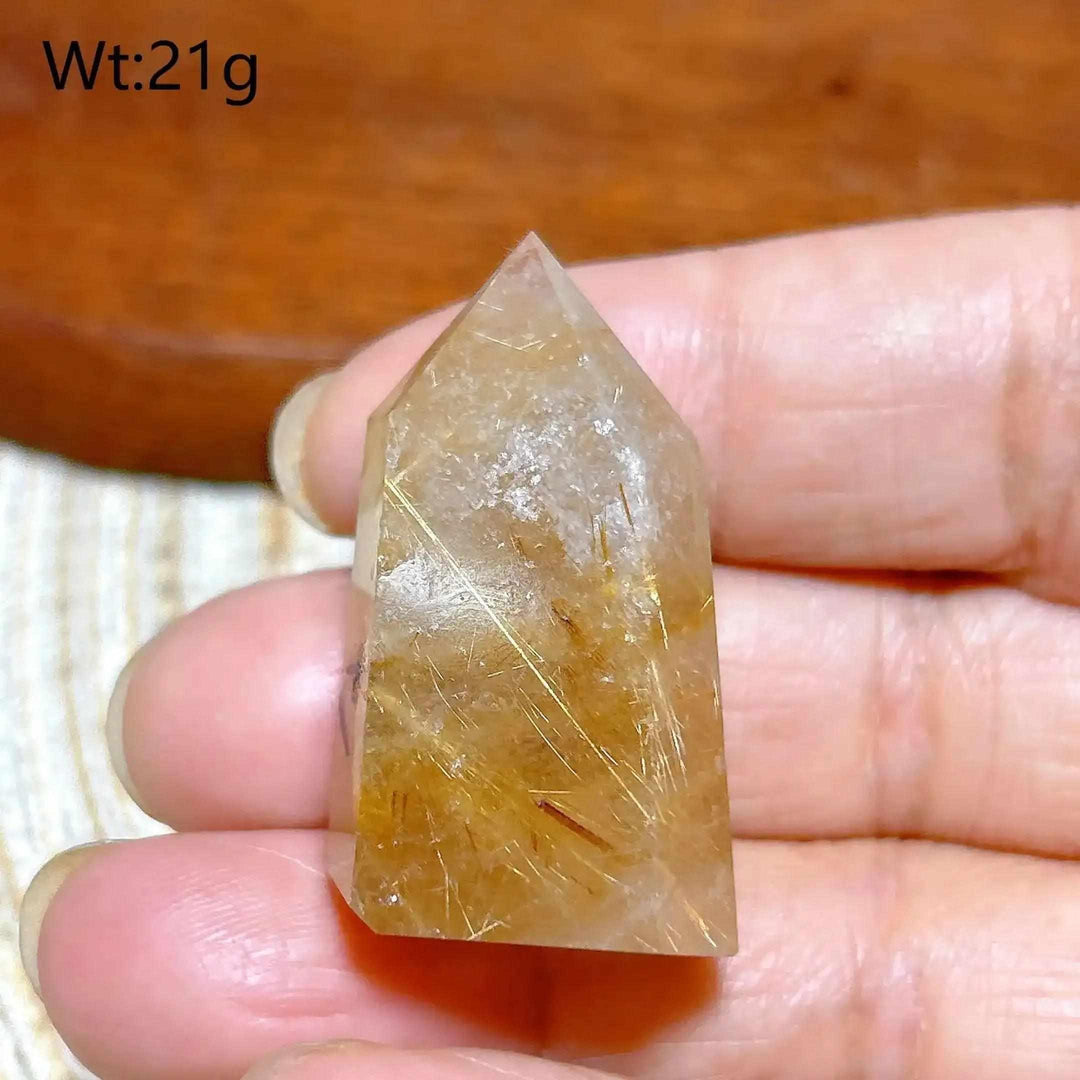Hand-polished Golden Rutilated Quartz tower with fine golden needles, perfect for meditation and energy amplification.