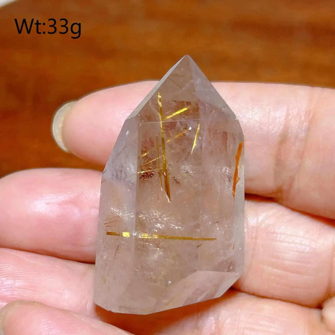 Hand-polished Golden Rutilated Quartz tower with clear crystal and vibrant golden needles for amplified energy.