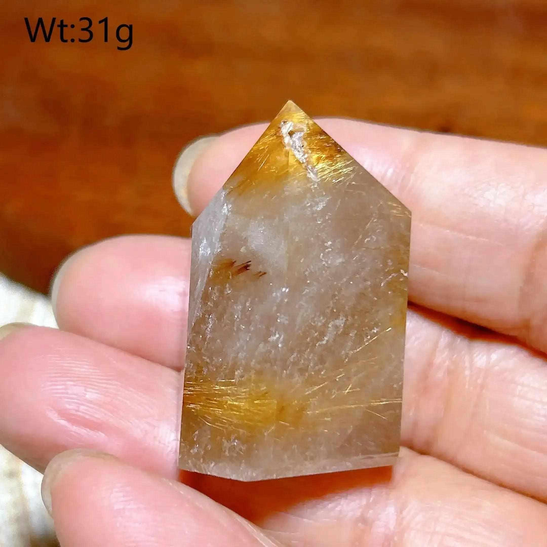 Hand-polished Golden Rutilated Quartz tower with golden needles, perfect for amplifying energy and focus.