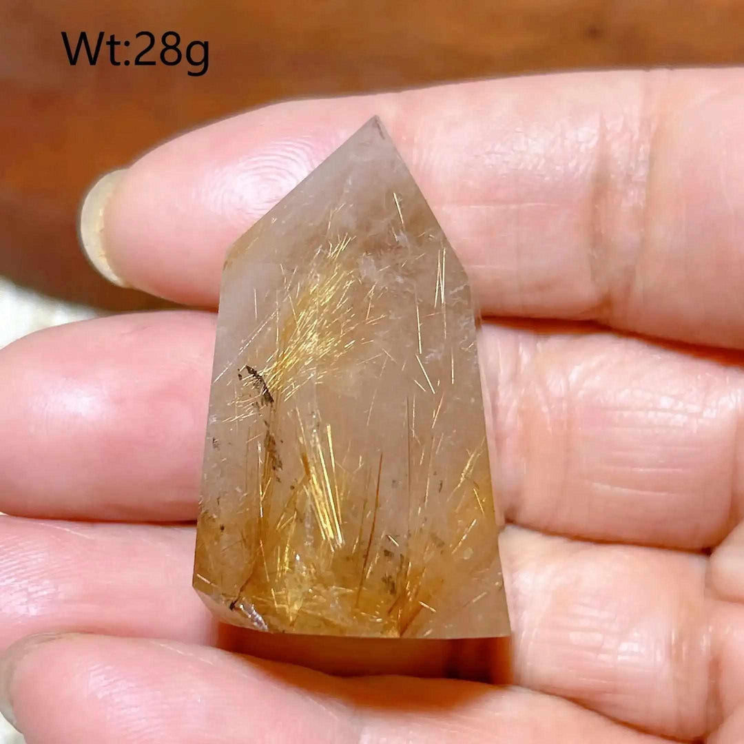 Hand-polished Golden Rutilated Quartz tower with fine golden needles, perfect for meditation and energy amplification.