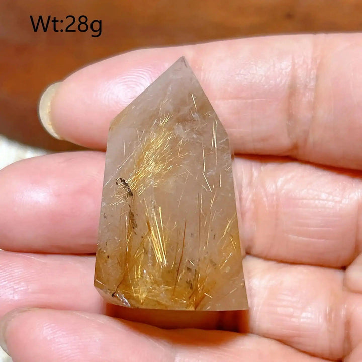 Hand-polished Golden Rutilated Quartz tower with fine golden needles, perfect for meditation and energy amplification.