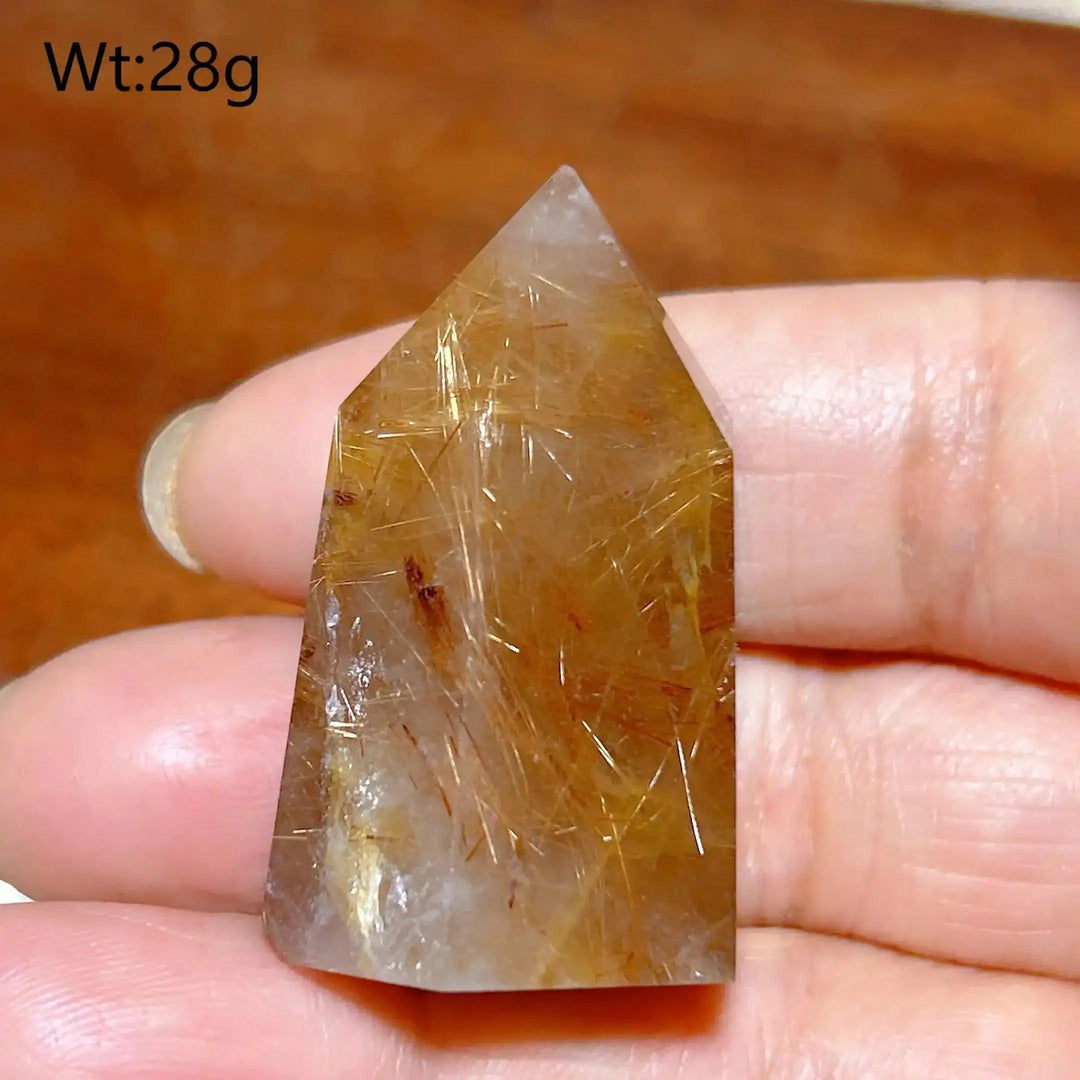 Hand-polished Golden Rutilated Quartz tower featuring clear crystal with shimmering golden needles for focused energy.