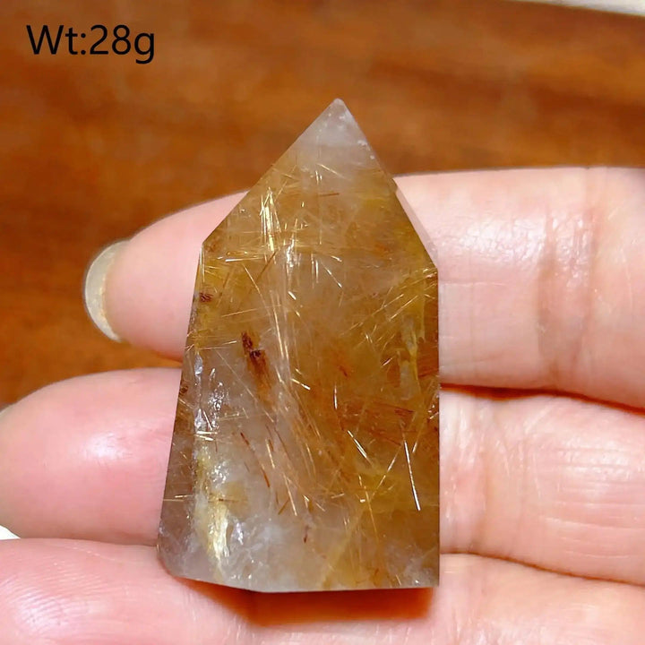 Hand-polished Golden Rutilated Quartz tower featuring clear crystal with shimmering golden needles for focused energy.