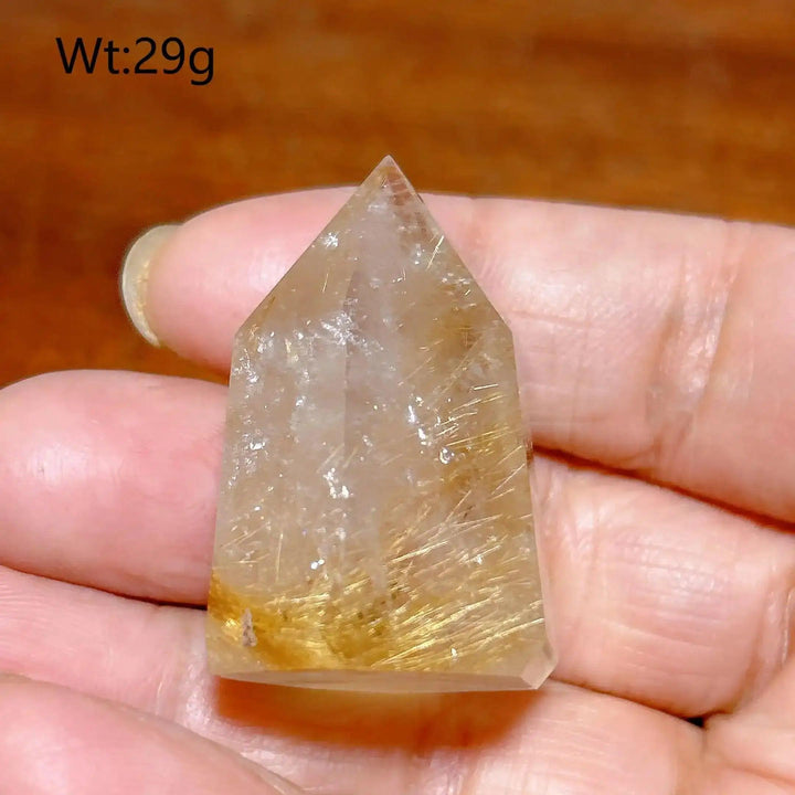 Hand-polished Golden Rutilated Quartz tower with fine golden needles, perfect for amplifying energy and focus.
