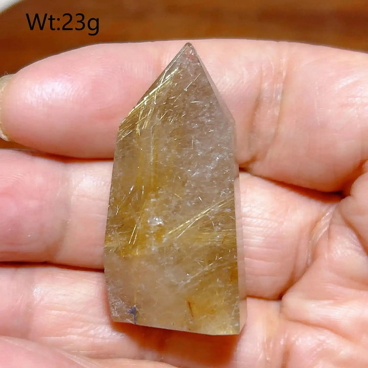 Hand-held Golden Rutilated Quartz tower with clear crystal and fine golden needles for amplified energy and focus.