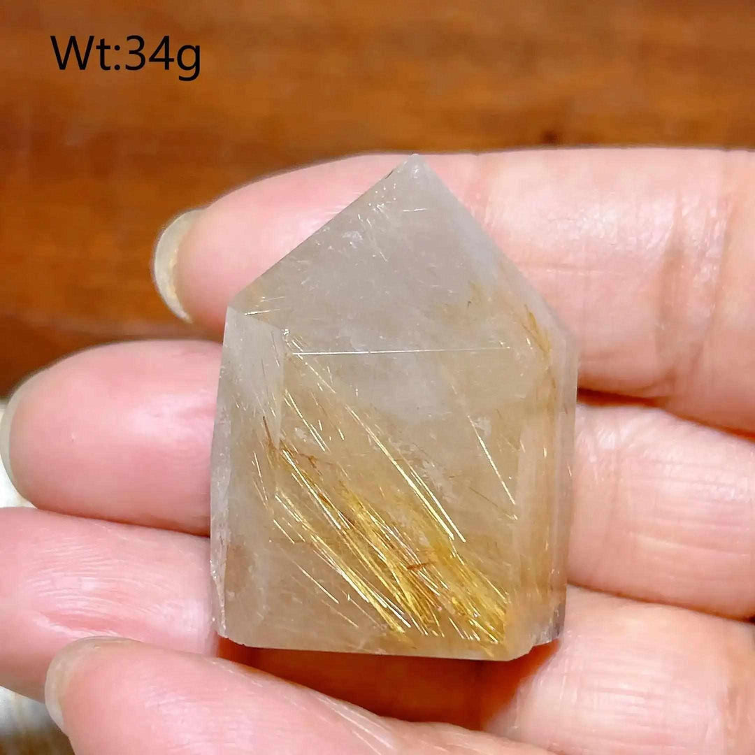 Hand-polished Golden Rutilated Quartz tower with fine golden needles, perfect for focus and energy manifestation.
