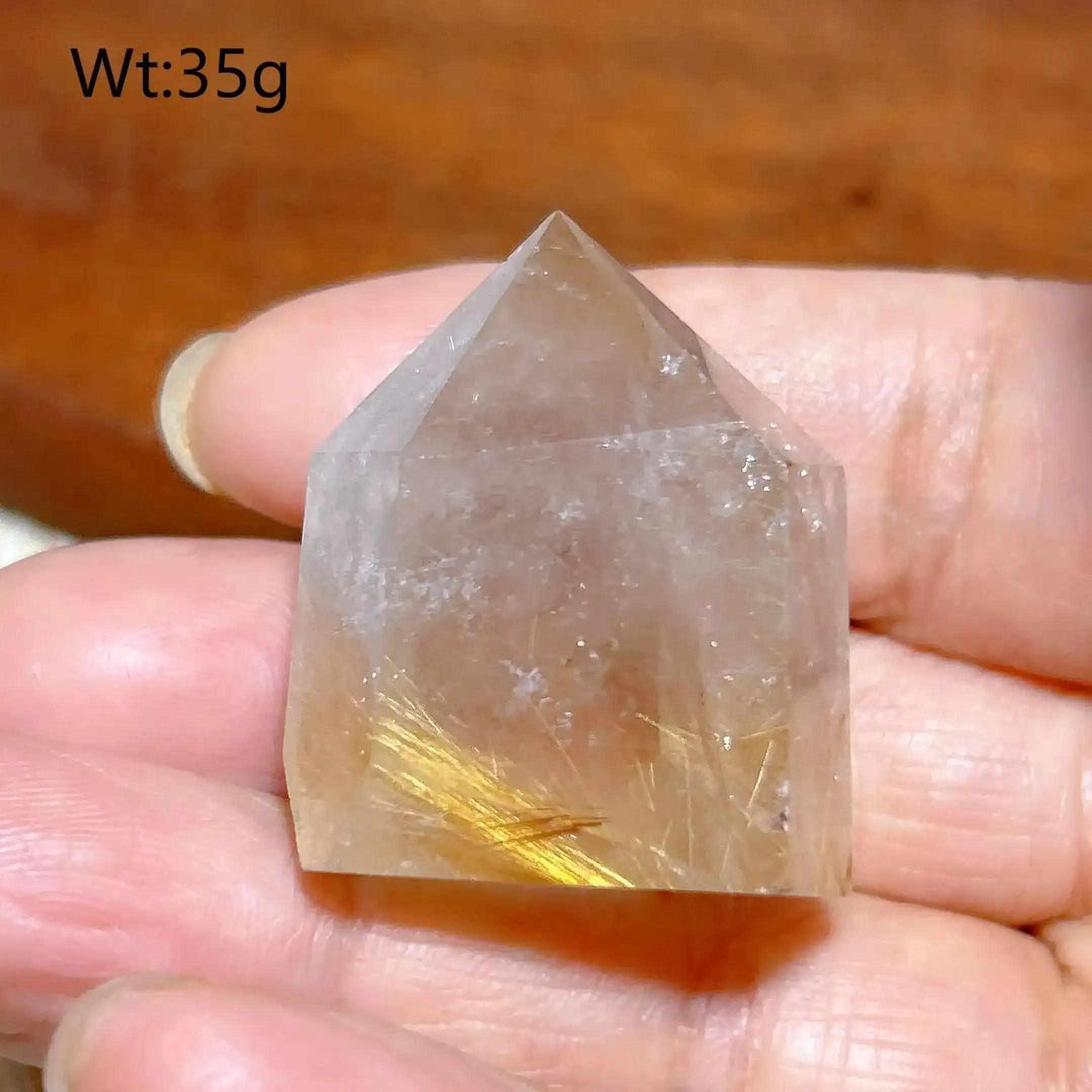 Hand-polished Golden Rutilated Quartz tower with fine golden needles, perfect for focused energy and meditation.