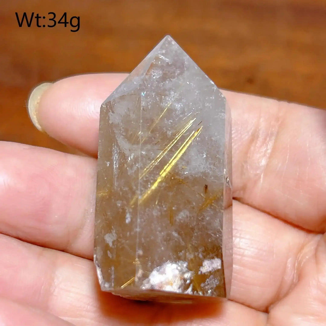Hand-polished Golden Rutilated Quartz tower with clear crystal and vibrant golden needles for amplified energy.