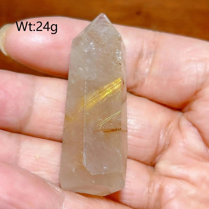 Hand-polished Golden Rutilated Quartz tower with fine golden needles, perfect for meditation and energy amplification.