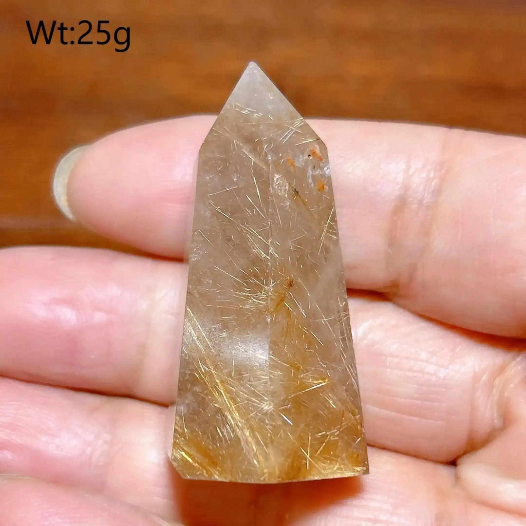 Hand-polished Golden Rutilated Quartz tower with fine golden needles, perfect for meditation and energy amplification.