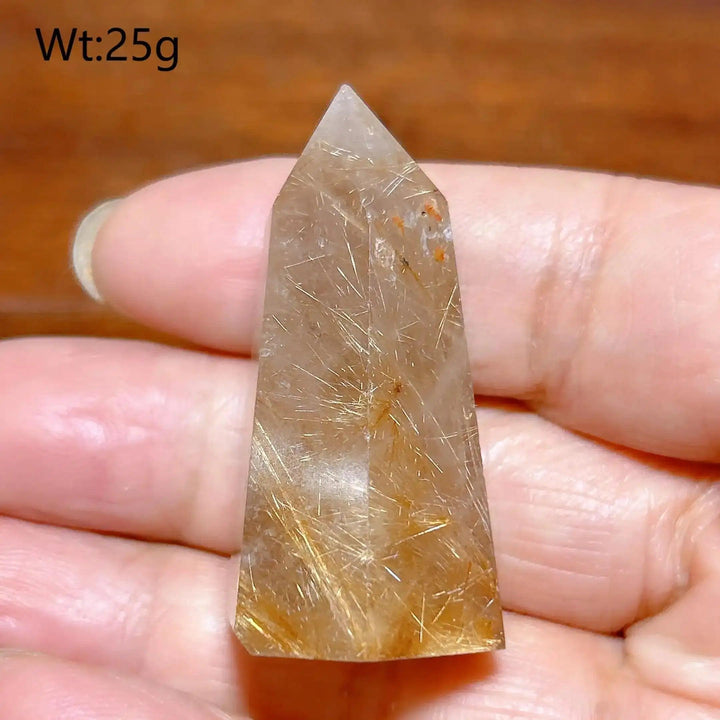 Hand-polished Golden Rutilated Quartz tower with fine golden needles, perfect for meditation and energy amplification.