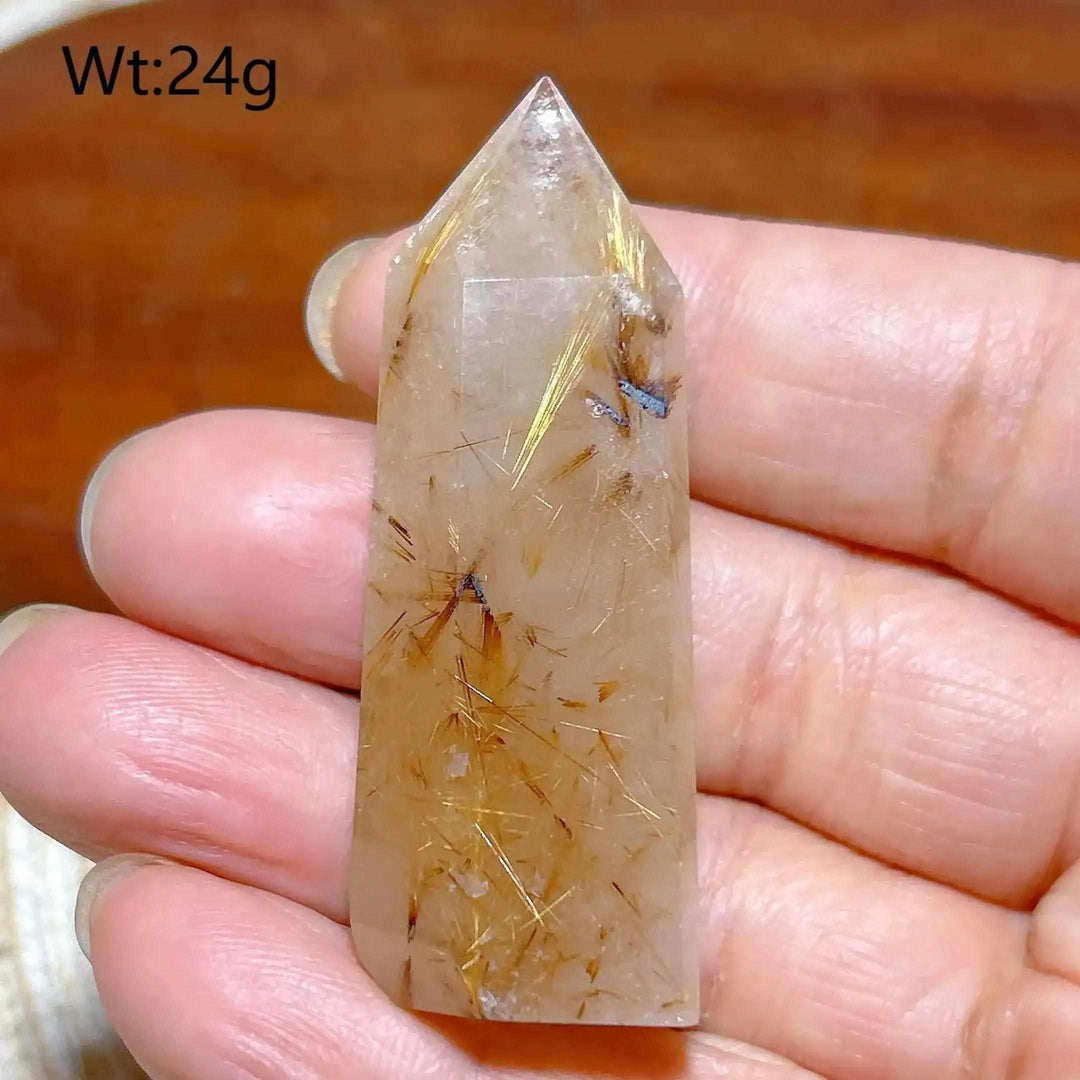Hand-held Golden Rutilated Quartz tower featuring clear crystal with fine golden rutile needles for amplified energy.