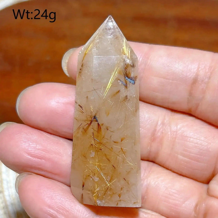 Hand-held Golden Rutilated Quartz tower featuring clear crystal with fine golden rutile needles for amplified energy.