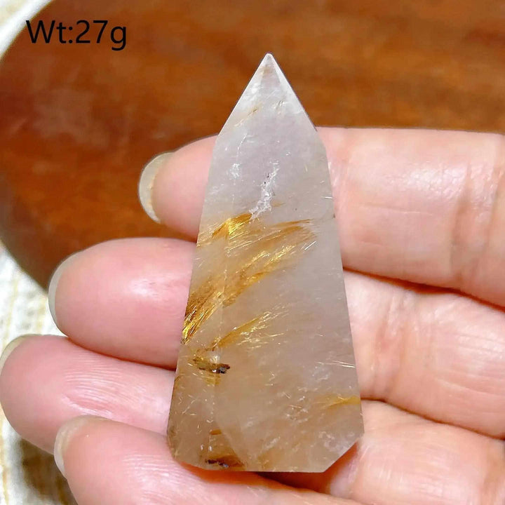 Hand-polished Golden Rutilated Quartz tower with golden needles, perfect for focusing energy and intention.