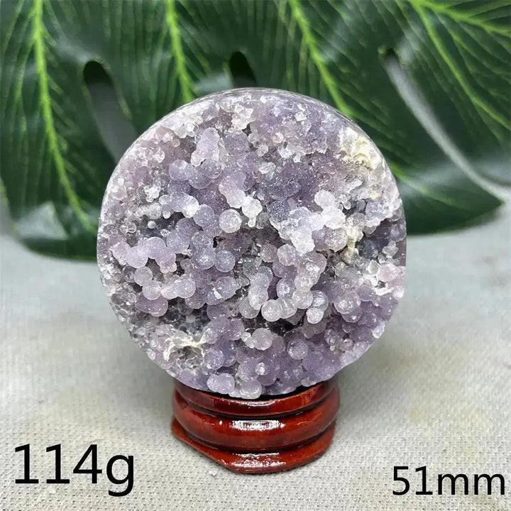 Indonesian Grape Agate Crystal Sphere: Polished orb with shimmering lilac, lavender, and deep purple botryoidal formations.