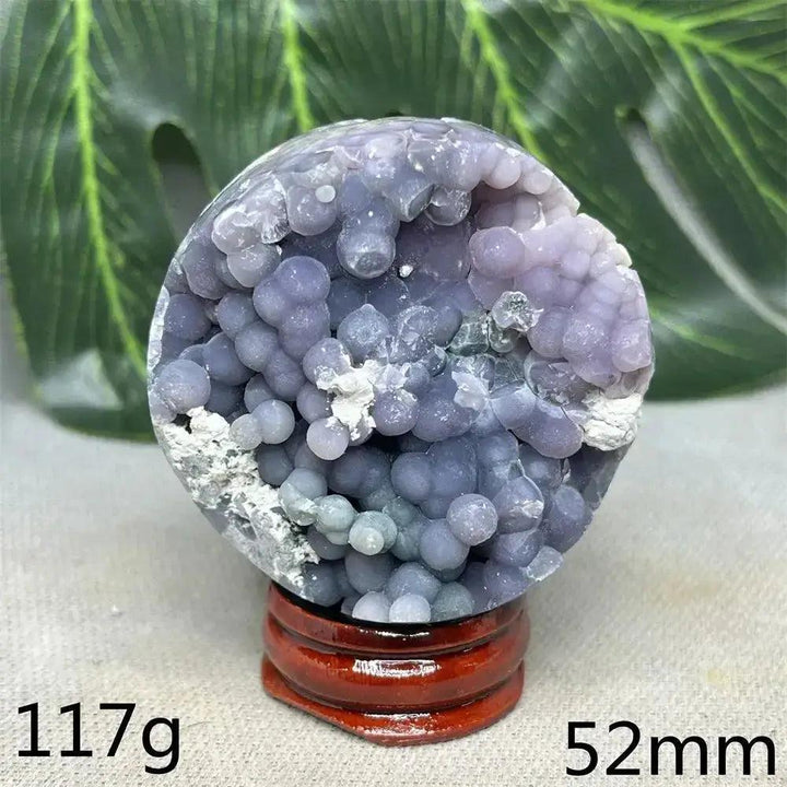 Indonesian Grape Agate Crystal Sphere, 117g, 52mm. Lilac, lavender, deep purple botryoidal formations on a wooden stand.