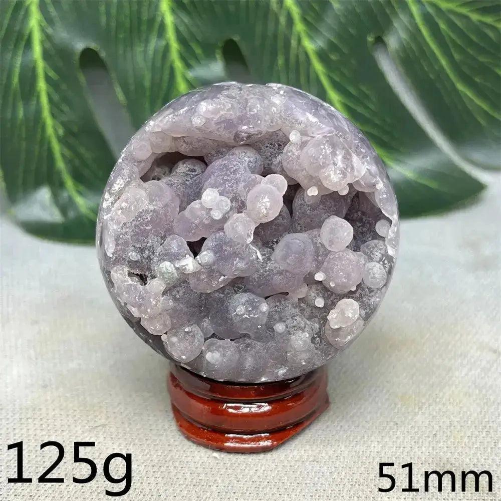 Indonesian Grape Agate Crystal Sphere: Polished orb with rare botryoidal lilac, lavender, and deep purple nodules. Soothing energy.