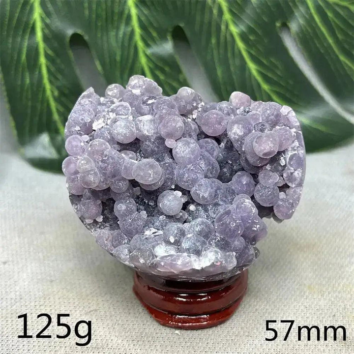 Indonesian Grape Agate Crystal Sphere with rare botryoidal lilac and deep purple nodules, 125g, 57mm, on a wooden stand.