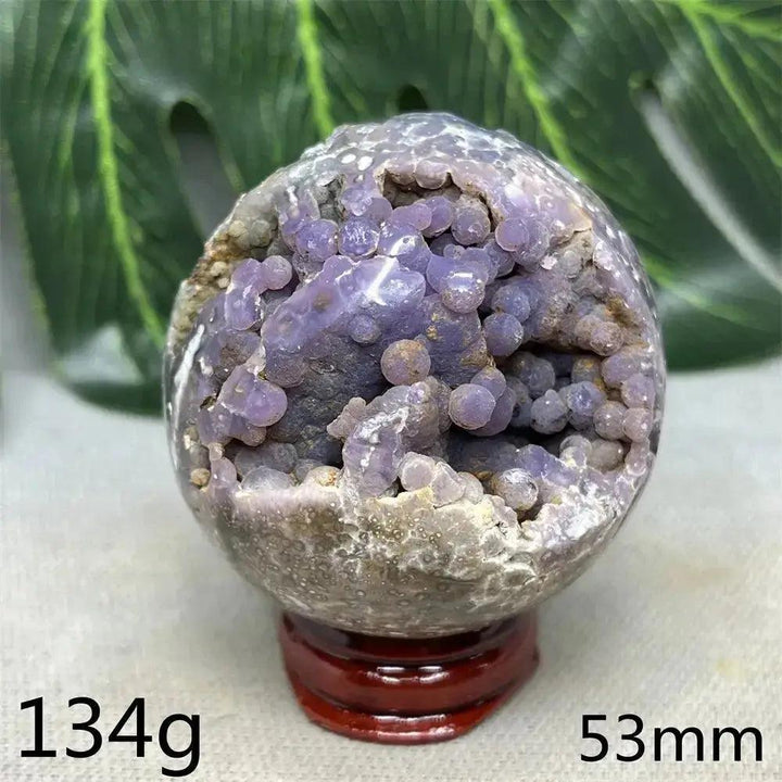 Indonesian Grape Agate Crystal Sphere: Polished orb with shimmering lilac, lavender, and deep purple botryoidal formations.