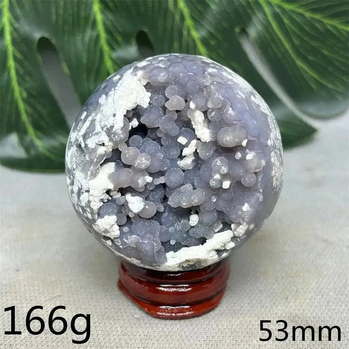 Indonesian Grape Agate Crystal Sphere: Lilac, lavender, deep purple botryoidal formations, polished orb on wood stand. Soothing energy.
