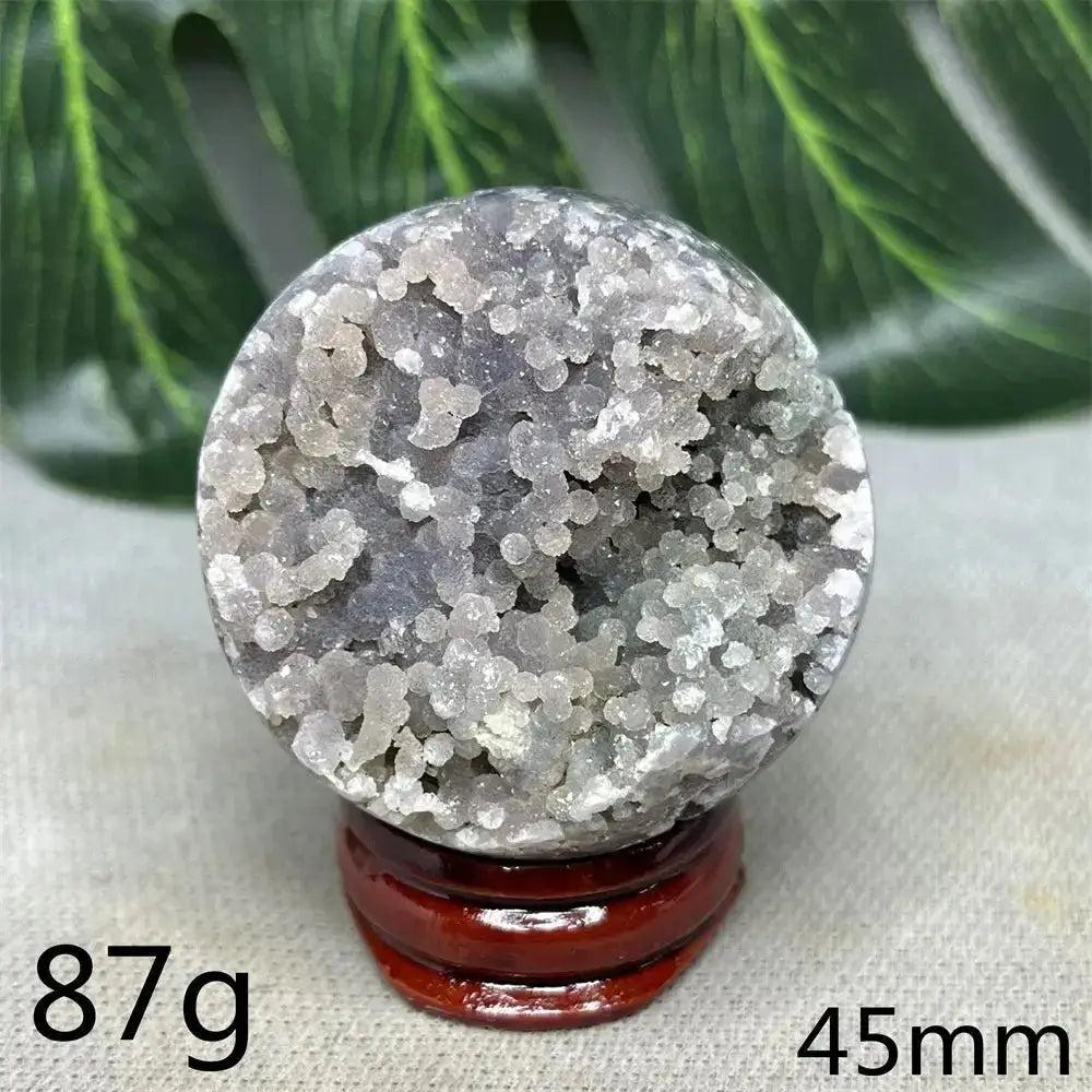 Indonesian Grape Agate Crystal Sphere: Lilac, lavender, and deep purple botryoidal formations, 87g, 45mm, on wood stand.