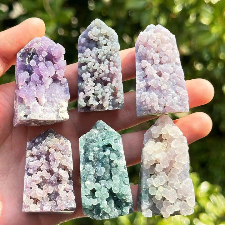 Six Grape Agate towers in purple, lavender, and teal, showcasing botryoidal formations from Crystal Destiny.